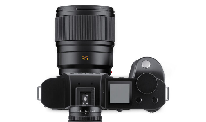 studio image of a Leica camera and lens